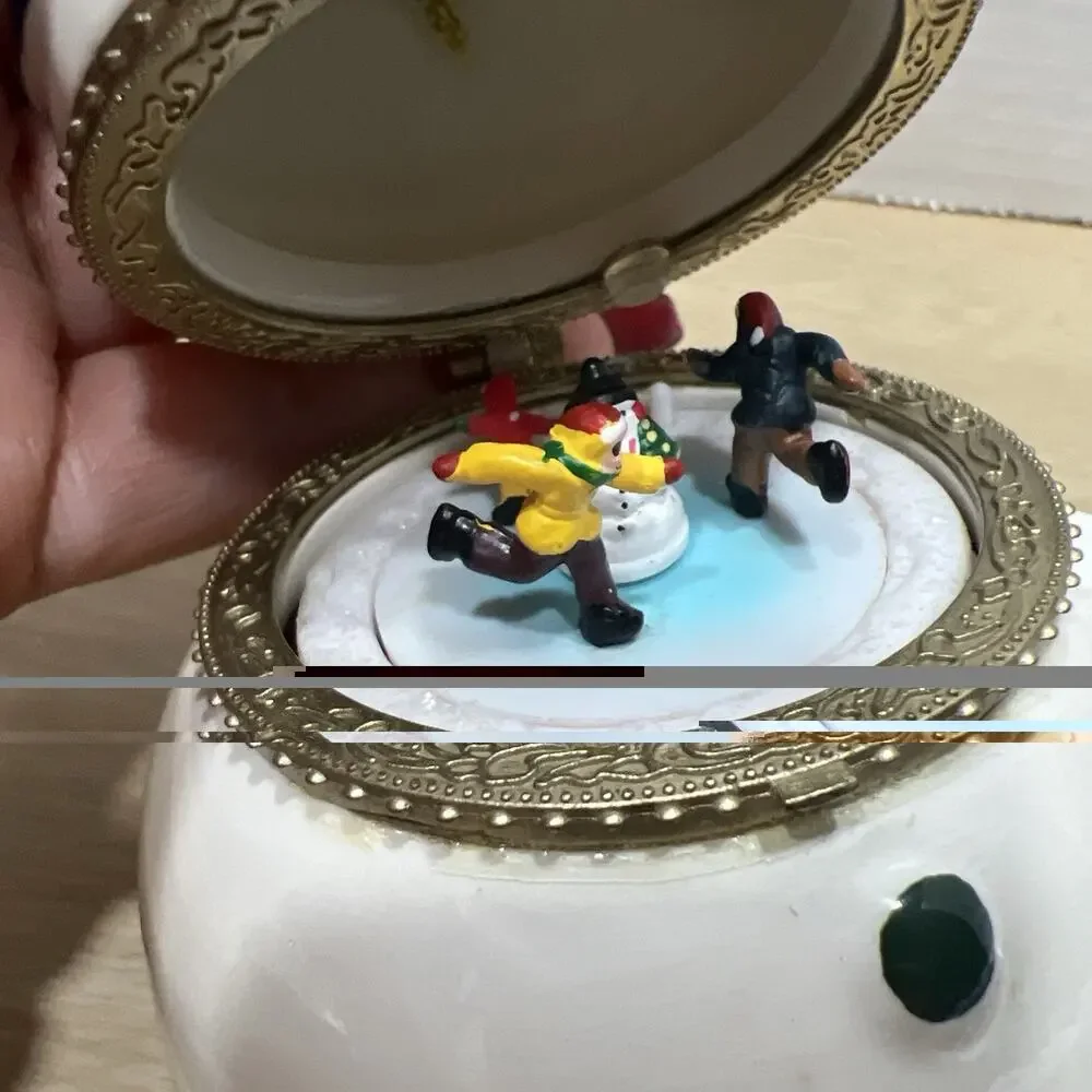 Mr. Christmas Porcelain Snowman is a Hinged Music Box Ornament
